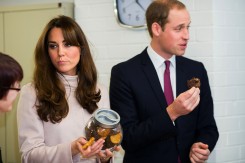Britain's Catherine, Duchess of Cambridge and Prince William sample some biscuits cooked in the shelter's kitchen during a visit to an accommodation and resettlement centre called 'Jimmy's'  in Cambridge