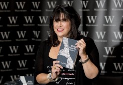 E L James, author of Fifty Shades of Grey, poses for photographers during a book signing in London