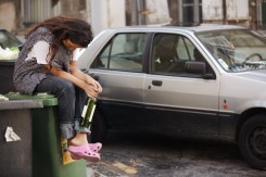drunk woman sitting on bin